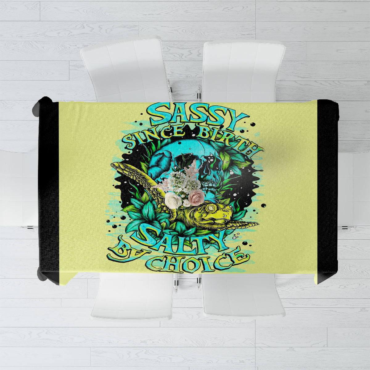 Yellow tablecloth with centered turtle skull graphic and text design, teal and blue colors