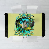Yellow tablecloth with centered turtle skull graphic and text design, teal and blue colors