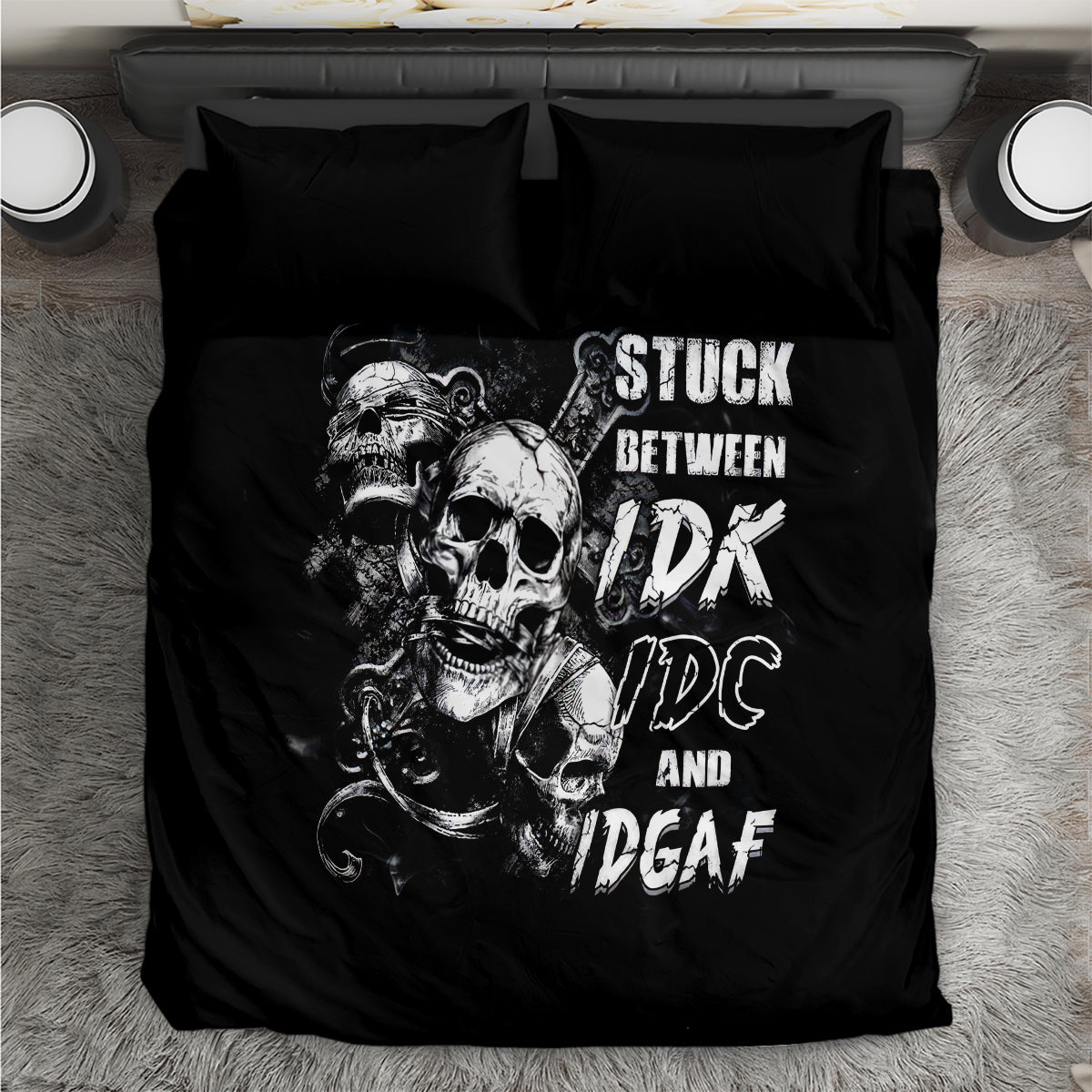 Black bedding set with large skull artwork and 'STUCK BETWEEN' lettering on duvet