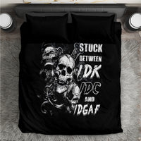 Black bedding set with large skull artwork and 'STUCK BETWEEN' lettering on duvet