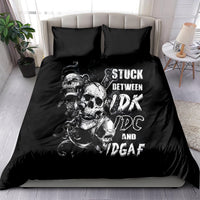 Black bedding set with skull graphic and bold 'STUCK BETWEEN' text on comforter
