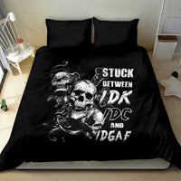 Black skull bedding set with 'STUCK BETWEEN' text on duvet and two matching pillowcases