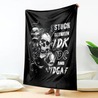 Black skull graphic throw blanket with white text design, held upright