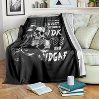 Black skull graphic throw blanket with white text, draped over a couch arm
