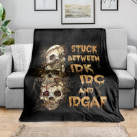 Black skull graphic throw blanket with gold text on a sofa
