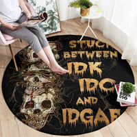 Black round area rug with gold skull graphic and dripping graffiti-style lettering