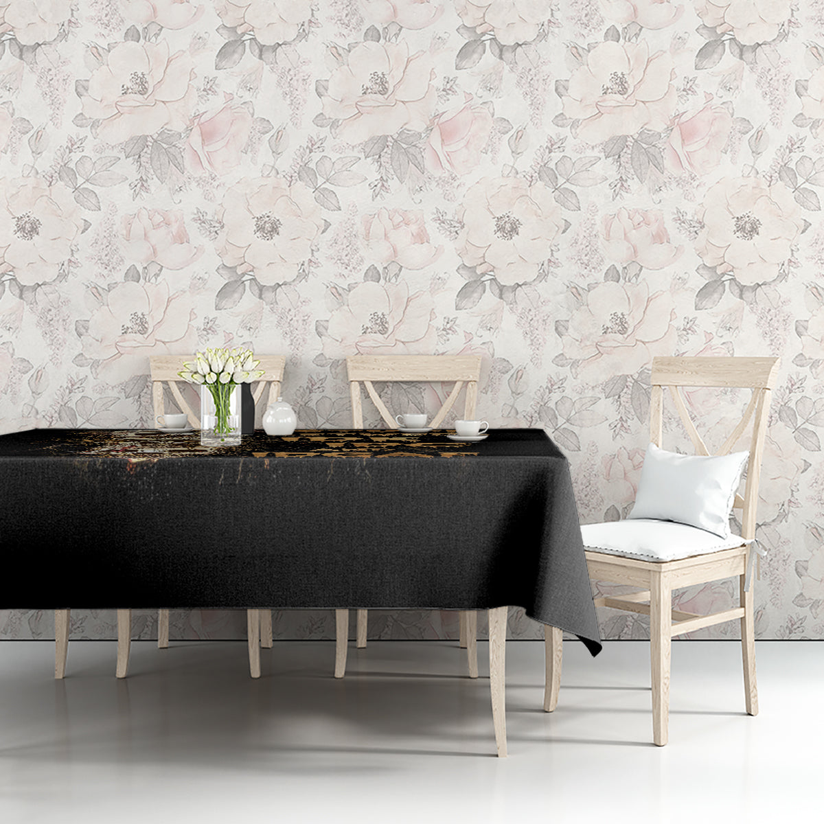 Black skull graphic tablecloth covering table with decor items and chairs