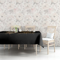 Black skull graphic tablecloth covering table with decor items and chairs