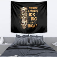Black skull tapestry with gold lettering and skull collage design