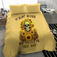 Yellow bedding set on bed with duvet and pillows; sunflower skull design and lettering.