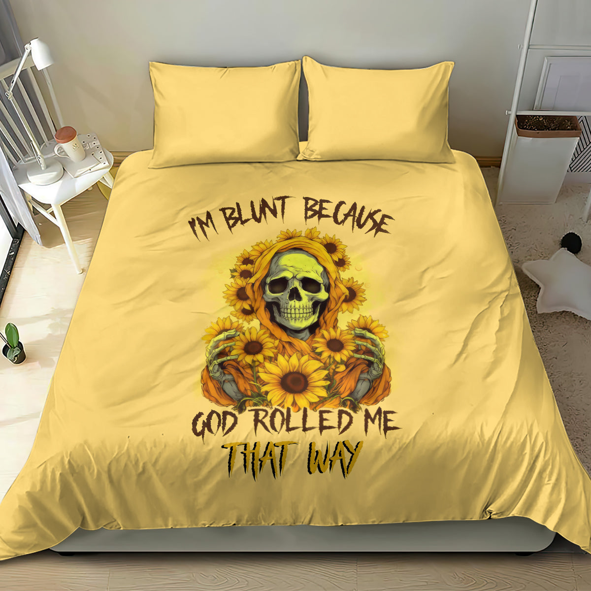 Yellow bedding set with duvet and two pillows; large centered skull and sunflower artwork.