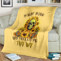 Yellow skull and sunflower throw blanket draped over a couch back