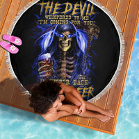 Black round beach blanket with skull-reaper graphic and blue flames, white fringe edge