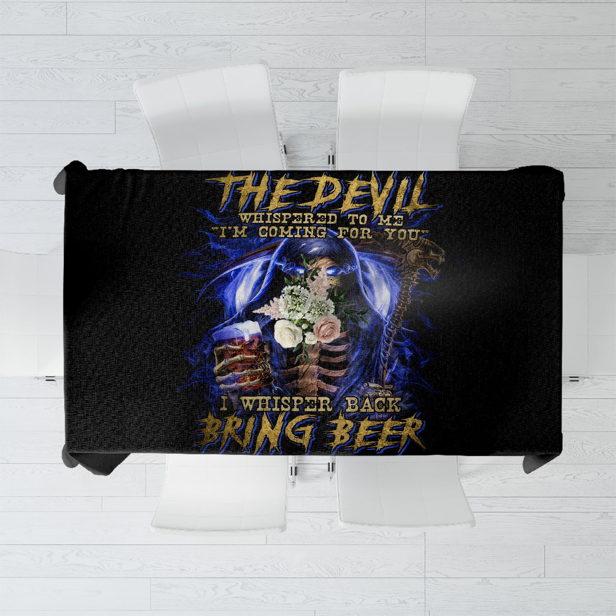 Black tablecloth with blue skull artwork and quote lettering, top-down over tabletop