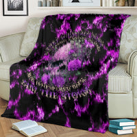 Purple electric lightning skull rose blanket laid across striped armchair