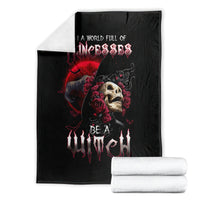 Black witch skull blanket display with stacked white rolls beside it