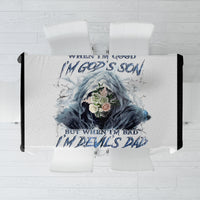 White tablecloth laid flat with blue skull graphic and slogan text