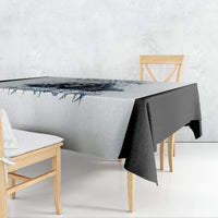 White tablecloth with blue skull graphic and text, draped over table