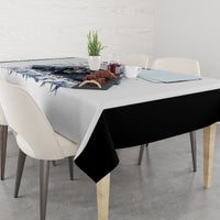 White tablecloth with blue skull graphic and text, table with folded corner
