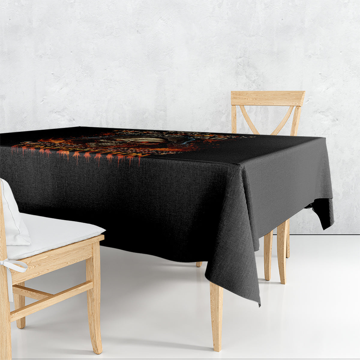 Black tablecloth with flame skull graphic and orange dripping accents on tabletop