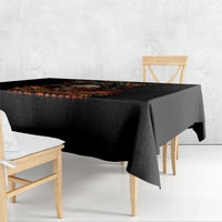 Black tablecloth with flame skull graphic and orange dripping accents on tabletop