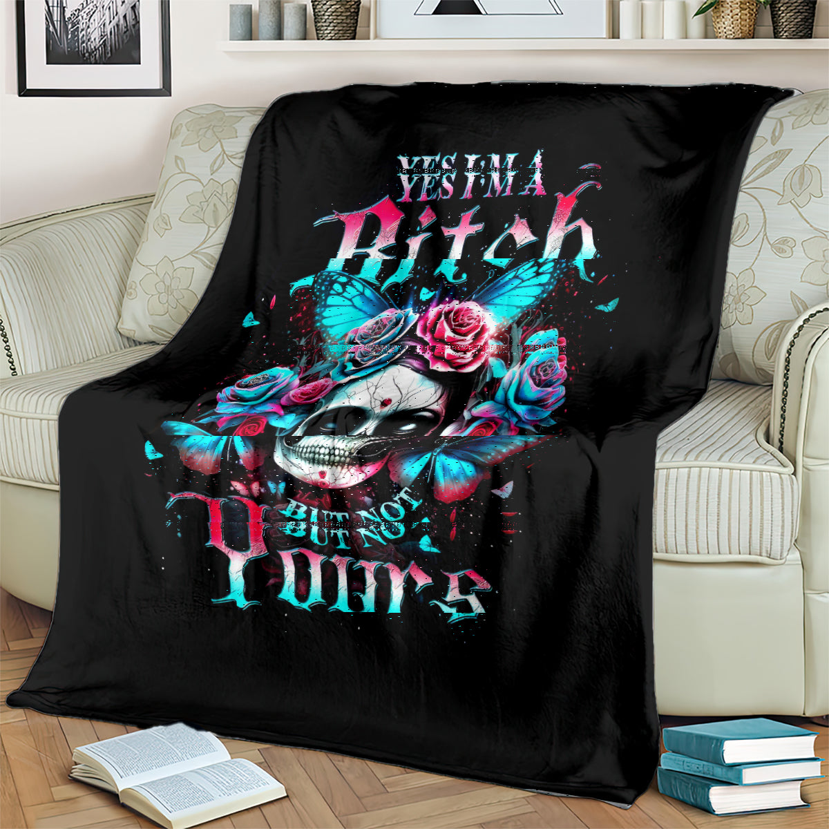 Black skull blanket with teal butterflies and pink roses, draped on a sofa