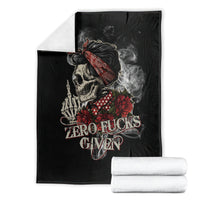Black skull and rose graphic blanket with 'ZERO FUCKS GIVEN' text, folded with stacks