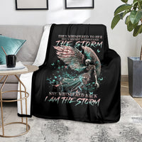 Black angel skull throw blanket on sofa, winged skull graphic and 'I AM THE STORM'