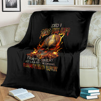 Black throw blanket with flaming skull artwork, draped over couch seat