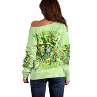 Green off-shoulder sweater, back print with skull and “Drink up Bitches” text