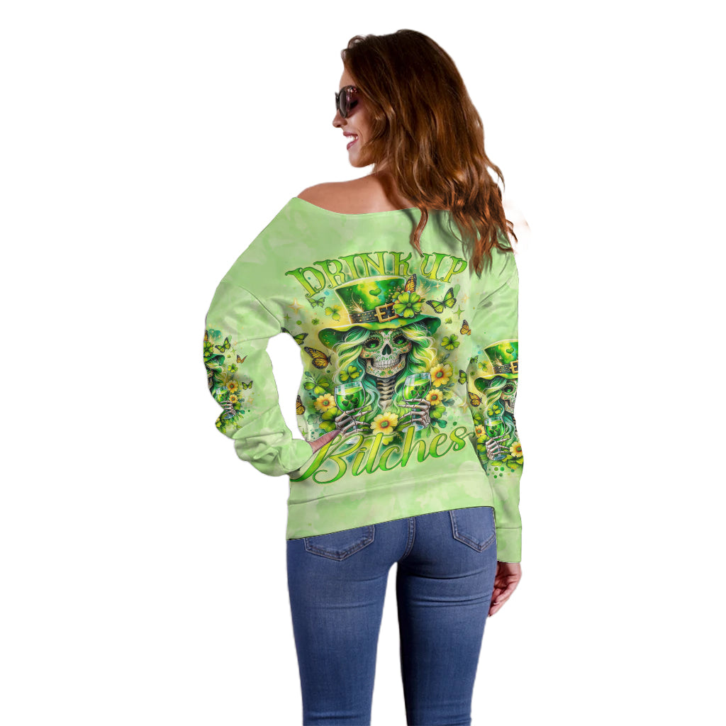 Green off-shoulder sweater, back view with skull, flowers, and “Drink up Bitches”