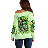 Light green off-shoulder sweater, long sleeves, large skull graphic on back