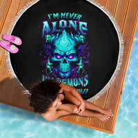 Black round beach blanket with fringe, blue skull graphic and neon text on it