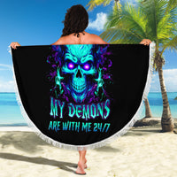 Black round beach blanket with fringe, neon skull graphic, spread out on sand