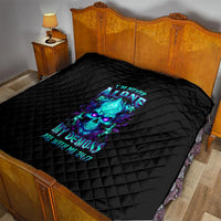 Black quilt blanket with neon blue flame skull graphic laid on a bed