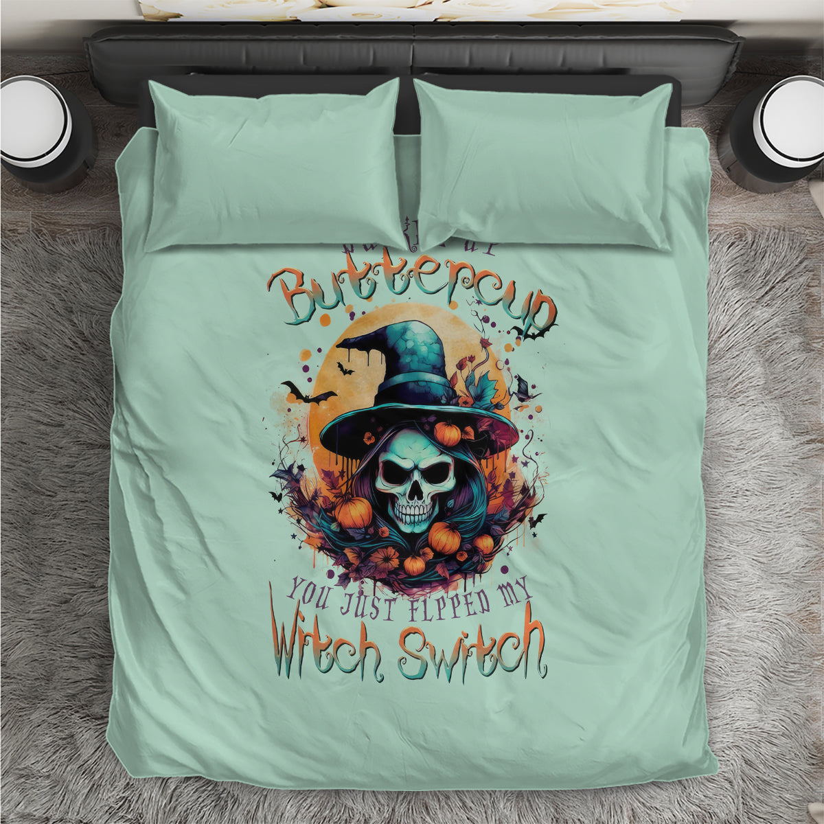 Mint blue bedding set laid flat with witch skull artwork and two pillowcases