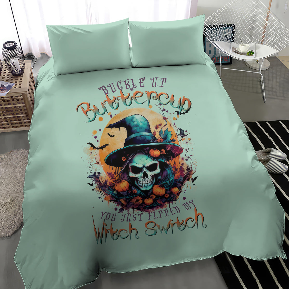 Mint blue bedding set with witch skull design and two matching pillowcases, angled view