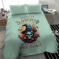 Mint blue bedding set with witch skull design and two matching pillowcases, angled view