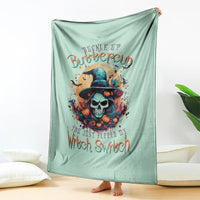 Mint green witch skull graphic throw blanket, hanging with full front design