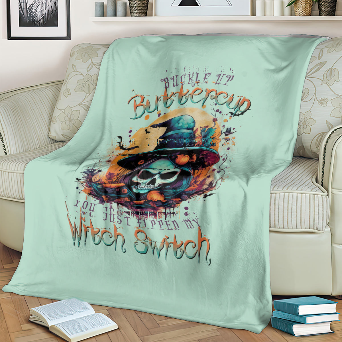 Mint green witch skull graphic throw blanket with large central skull and hat illustration