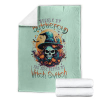 Mint green witch skull graphic throw blanket, folded, with Buckle Up and Witch Switch text