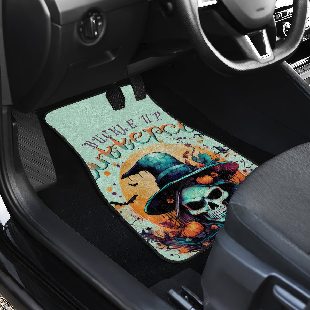 Witch skull graphic car floor mat in vehicle footwell, mint background and hat artwork