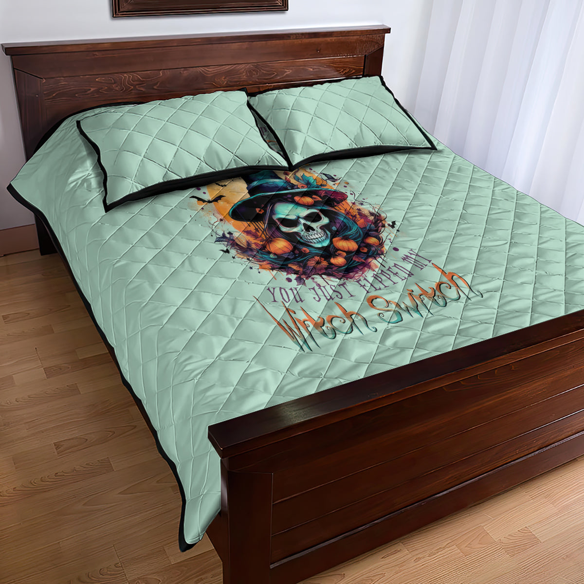 Seafoam blue quilt bed set with skull witch artwork on quilt top, includes two pillows