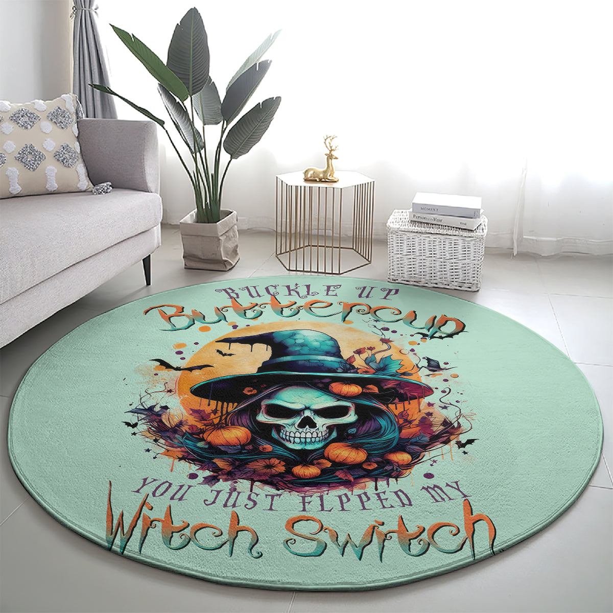 Teal round witch skull rug with skull-in-hat artwork and spell lettering, shown from above