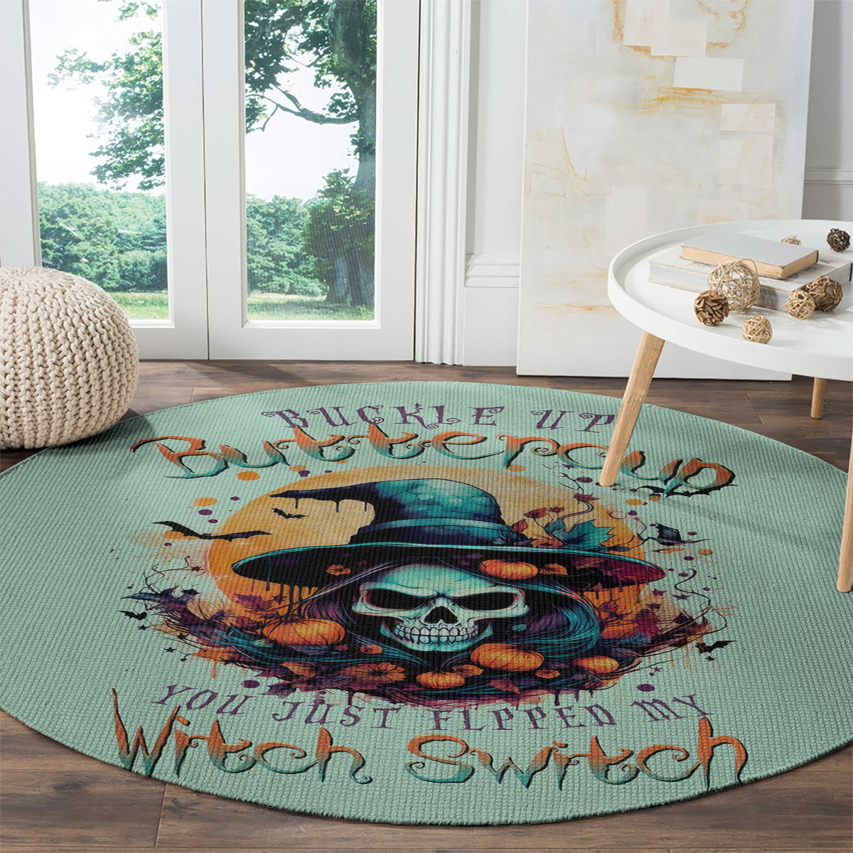 Teal round witch skull rug with orange pumpkin skull graphic and dark spell text along the edge