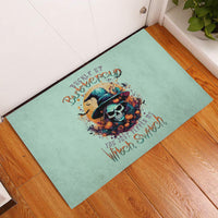 Teal rubber doormat showing witch skull illustration with 'Buckle Up Buttercup' text