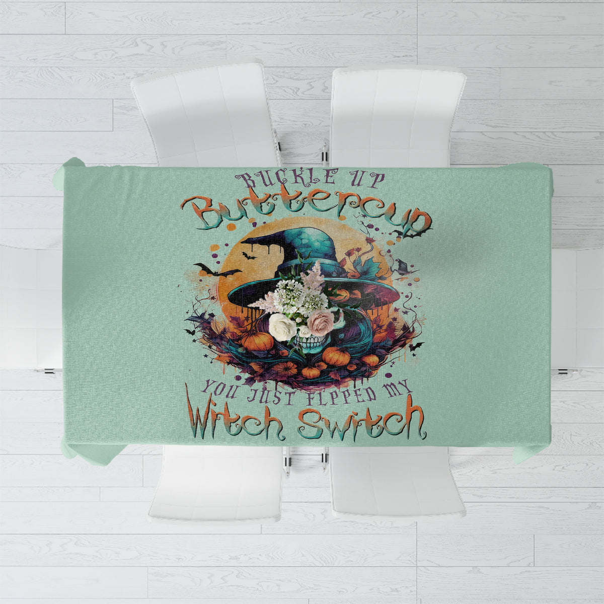 Mint green tablecloth close-up: witch skull design with “Witch Switch” text