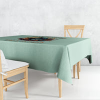 Mint green tablecloth with witch skull artwork and decorative lettering