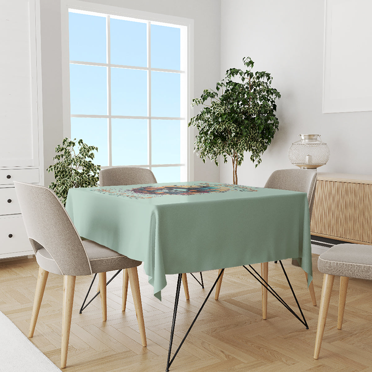 Mint green tablecloth on dining table featuring witch skull graphic across center