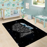 Black area rug with starry galaxy print, sad skull and quote typography centerpiece